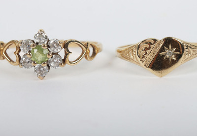 A group of four 9ct rings, including a 9ct ruby flower set ring, with a peridot and diamond ring, a sapphire and diamond ring and a 9ct signet ring, - 3