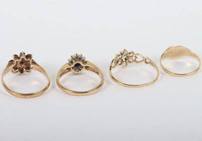 A group of four 9ct rings, including a 9ct ruby flower set ring, with a peridot and diamond ring, a sapphire and diamond ring and a 9ct signet ring, - 4