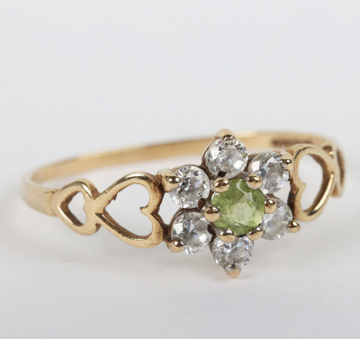 A group of four 9ct rings, including a 9ct ruby flower set ring, with a peridot and diamond ring, a sapphire and diamond ring and a 9ct signet ring, - 6