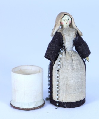 A sweet miniature painted wooden Grodnertal doll dressed as a Nun with pill box to skirt, German 1820s, - 2