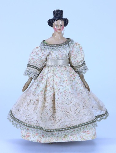 A small papier-mache shoulder head doll with Apollo knot, German 1840s,