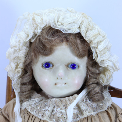 A wax over composition shoulder head doll, English circa 1860, - 2