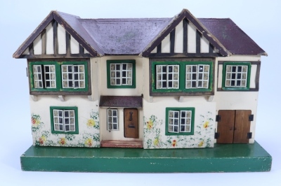 A Tri-ang dolls house with garage, English 1930s,