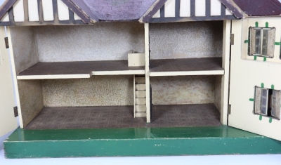 A Tri-ang dolls house with garage, English 1930s, - 2