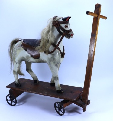 A painted carved wooden pull-along toy horse on wheels, English circa 1890, - 2