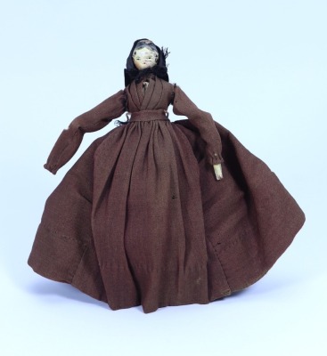 A painted wooden Grodnertal doll in original clothes, German circa 1820,