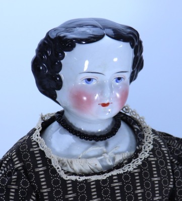 A glazed china shoulder head doll, German 1860s, - 2