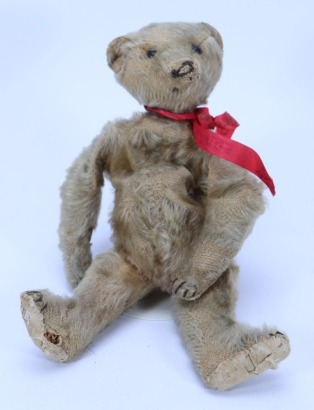 A small tan mohair Teddy bear, possibly Ideal circa 1909,