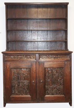 Unresolved and rare English style dresser, possibly taken to Benin by missionaries, and there carved with traditional figures etc including 1 with a flintlock gun
