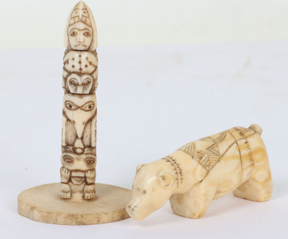 Inuit walrus tusk spear rest in the form of a bear with incised geometric decoration