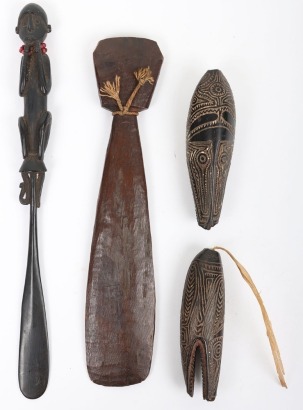 2 similar New Guinea carved hardwood or coconut charms