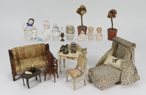 A collection of miniature figurines and dolls house furniture, circa 1910,