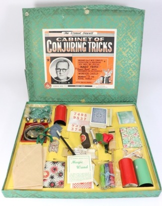 Earnest Sewell cabinet of Conjuring tricks and a selection of board and parlour games,