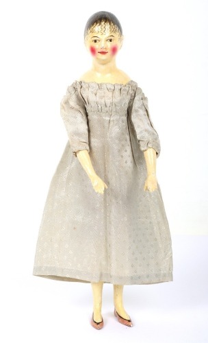 A rare and exquisite early painted carved wooden doll with her original extensive wardrobe, including seven gowns, nightdress and initialled undergarments, German circa 1810,