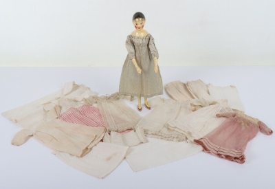 A rare and exquisite early painted carved wooden doll with her original extensive wardrobe, including seven gowns, nightdress and initialled undergarments, German circa 1810, - 2
