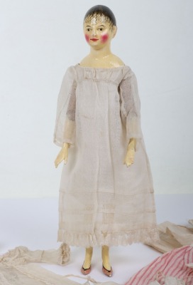 A rare and exquisite early painted carved wooden doll with her original extensive wardrobe, including seven gowns, nightdress and initialled undergarments, German circa 1810, - 5