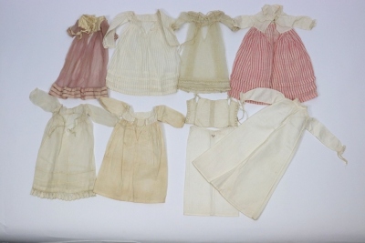 A rare and exquisite early painted carved wooden doll with her original extensive wardrobe, including seven gowns, nightdress and initialled undergarments, German circa 1810, - 10