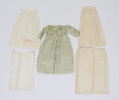 A rare and exquisite early painted carved wooden doll with her original extensive wardrobe, including seven gowns, nightdress and initialled undergarments, German circa 1810, - 11
