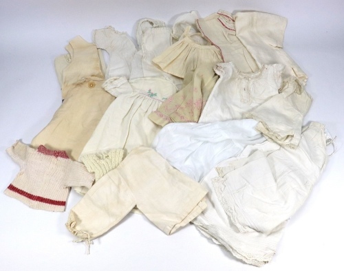 A good selection of dolls clothes,