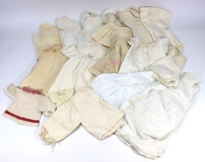 A good selection of dolls clothes,