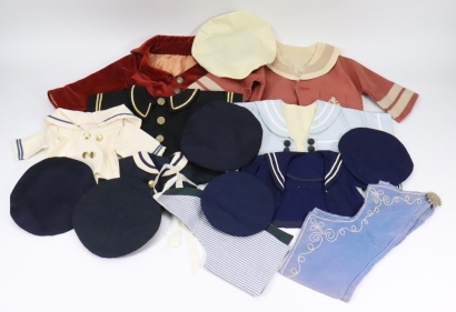 A good selection of dolls sailor style outfits,