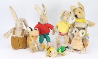 A pair of Schuco dressed rabbits and other soft toys,