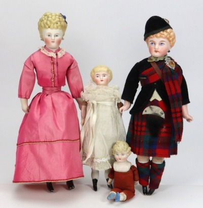 A Parian-type shoulder head doll in original Scottish clothes, circa 1890,