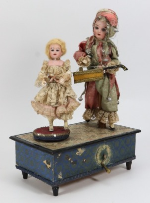 A musical hand wound toy with musician and dancing doll, German circa 1910,