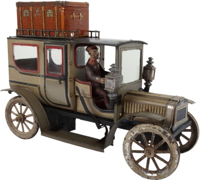 Carette tinplate clockwork Limousine, German circa 1909, finished in grey and black with cream lining and red window frames, roof with roof rack and running boards, hinged doors to rear, with glass windows, tinplate driver on padded style bench seat, two 