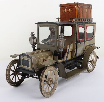 Carette tinplate clockwork Limousine, German circa 1909, finished in grey and black with cream lining and red window frames, roof with roof rack and running boards, hinged doors to rear, with glass windows, tinplate driver on padded style bench seat, two - 2