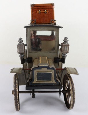 Carette tinplate clockwork Limousine, German circa 1909, finished in grey and black with cream lining and red window frames, roof with roof rack and running boards, hinged doors to rear, with glass windows, tinplate driver on padded style bench seat, two - 4