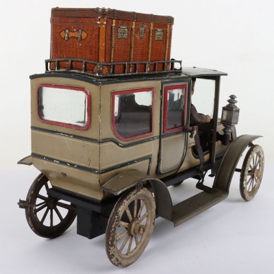 Carette tinplate clockwork Limousine, German circa 1909, finished in grey and black with cream lining and red window frames, roof with roof rack and running boards, hinged doors to rear, with glass windows, tinplate driver on padded style bench seat, two - 8