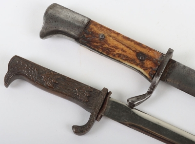 Miniature German K98 Bayonet, with wooden grips, blade engraved 'Andenken an den Weltkrieg'. No scabbard. Accompanied by a smaller bronze miniature of a German bayonet with oakleaves relief to the hilt and body. Also without scabbard. (2 items) - 3