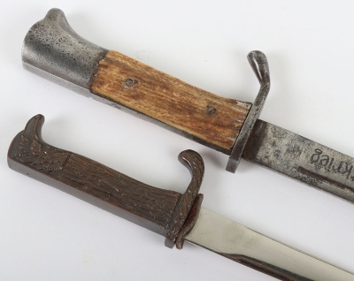 Miniature German K98 Bayonet, with wooden grips, blade engraved 'Andenken an den Weltkrieg'. No scabbard. Accompanied by a smaller bronze miniature of a German bayonet with oakleaves relief to the hilt and body. Also without scabbard. (2 items) - 4