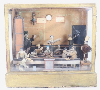 A Victorian diorama of a school classroom with master and unruly children, French