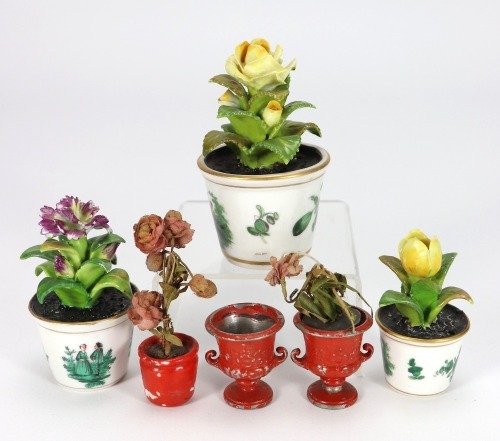 Three glazed china miniature flowers in plant pots,