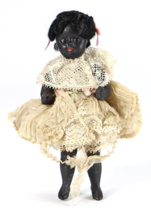 A rare black all-bisque miniature doll in original clothes, German circa 1890