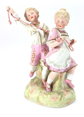 Gebruder Heubach bisque figurine young boy and girl holding rope, German circa 1905,