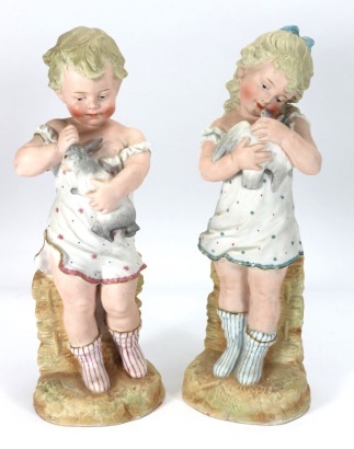 Gebruder Heubach pair of bisque children holding woodland animals, German circa 1900,