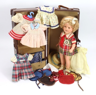 A Shirley Temple composition doll in her original travel trunk case with dresses and accessories, by Ideal, American 1935-40