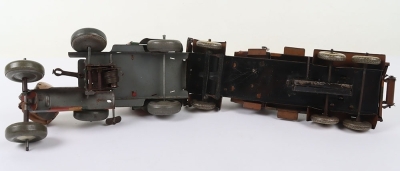 Mettoy Tinplate Military Searchlight Lorry, working clockwork motor, camouflaged tinplate body, searchlight, three tinplate soldiers, grey balloon tyres, in fair to good original condition, Approx.27 cms long and a Tippco Military Anti-Aircraft Lorry, lit - 5