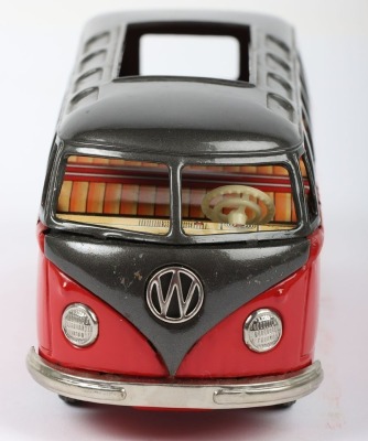 Bandai friction driven VW van, Japanese circa 1960, finished in red with dark grey top, chrome bumpers and tin printed interior, 7 3/4 (19.5cm) long - 3