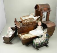 Collection of dolls in beds,