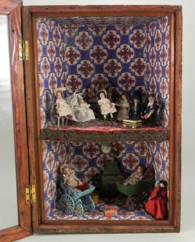 Glazed hanging wall cabinet with dolls and miniatures, dolls circa 1910,