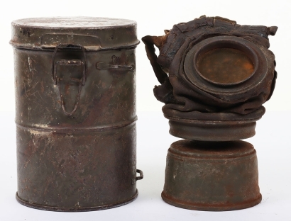 WW1 German M-17 Gas Mask, fine example of an original German M-17 leather faced gas mask which is complete with its original filter which has some rusting to the canister. Elasticated head straps still present and the original lenses. Housed in the origin
