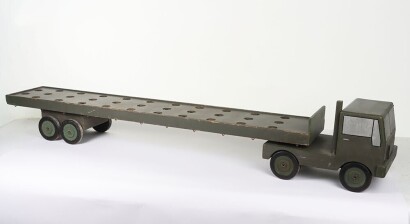 A large wooden Royal Engineers demonstration model of an Army truck and Low Loader, the solid wooden truck and low loader painted military green, cab with silver painted windows, lining, lights and other details in black, turned wooden wheels with black &lsquo;