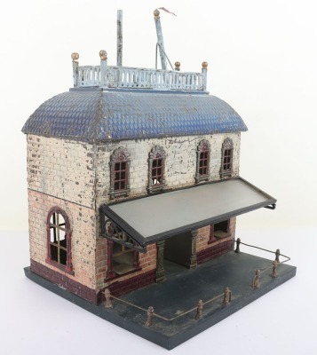 Bing 0 gauge Railway Station, brick effect building painted in shades of cream and orange, blue tiled effect roof, lithographed central arch and windows and glass tinplate framed canopy, 23.5cm wide, 22.5cm deep, 32cm high, fair condition, wear and paint - 2
