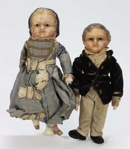 A pair of wax over composition dolls in original clothes, German circa 1860,
