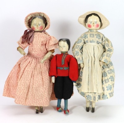 Three carved and painted wooden peg dolls,