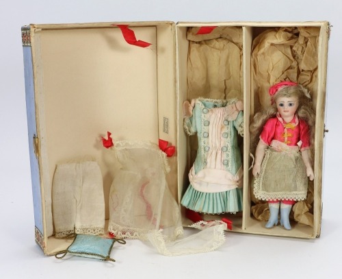 A rare miniature all bisque mignonette doll in trunk, French circa 1880,